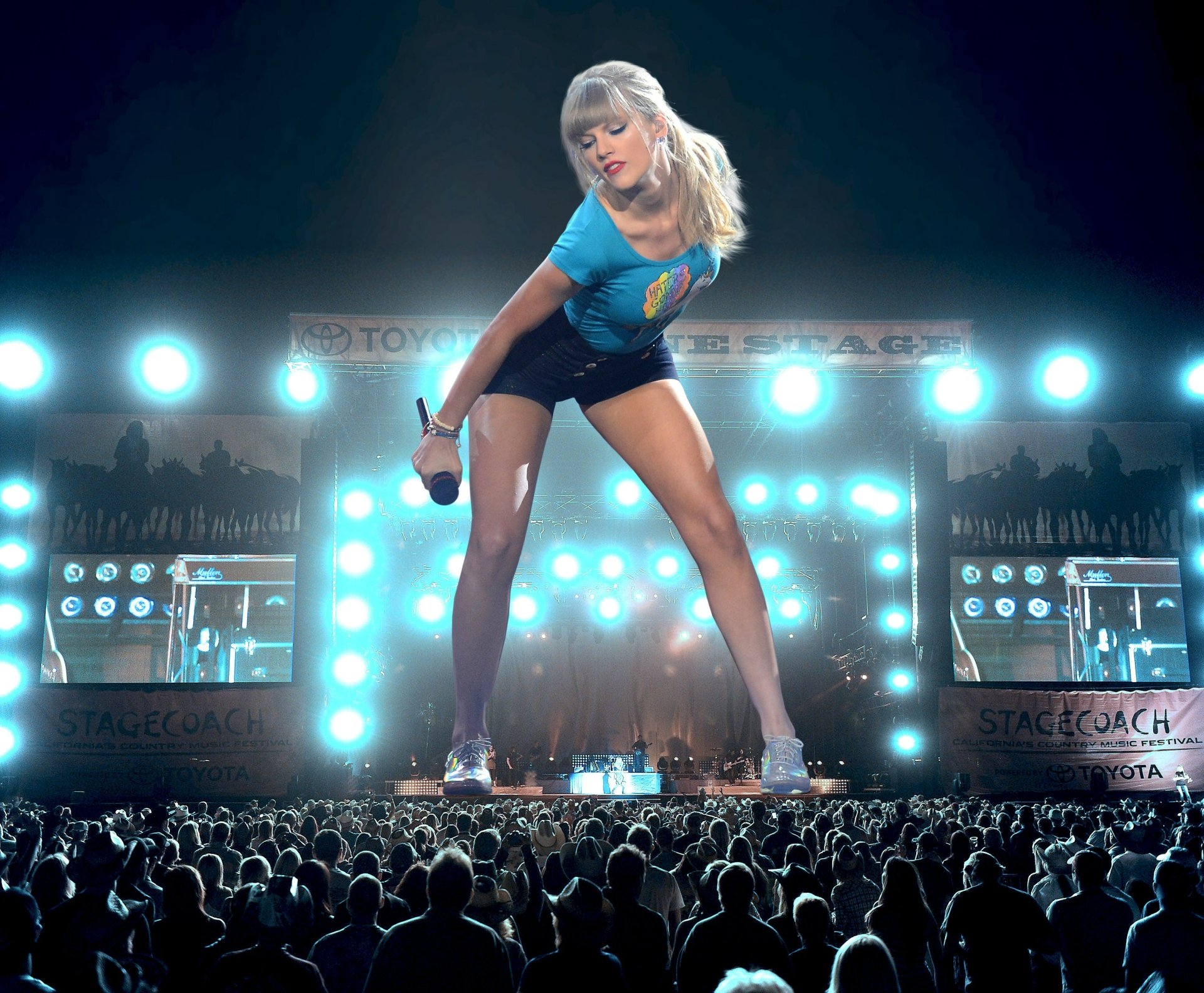 HD PC desktop wallpaper showing Taylor Swift performing on stage with bright lights and a large crowd, capturing vibrant music energy.