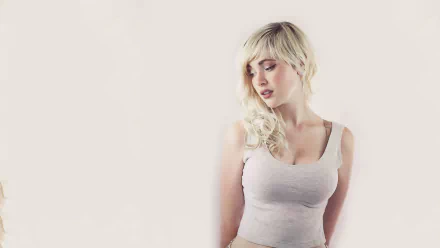 A high-definition desktop wallpaper featuring Devon Jade, a woman with blonde hair, thoughtfully gazing down, dressed in a light-colored top against a soft background.