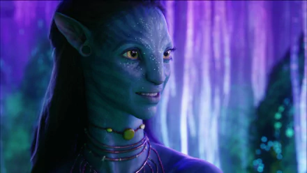 HD PC desktop wallpaper featuring a close-up of a blue-skinned Na'vi character from the movie Avatar, set against a glowing, bioluminescent purple forest background.