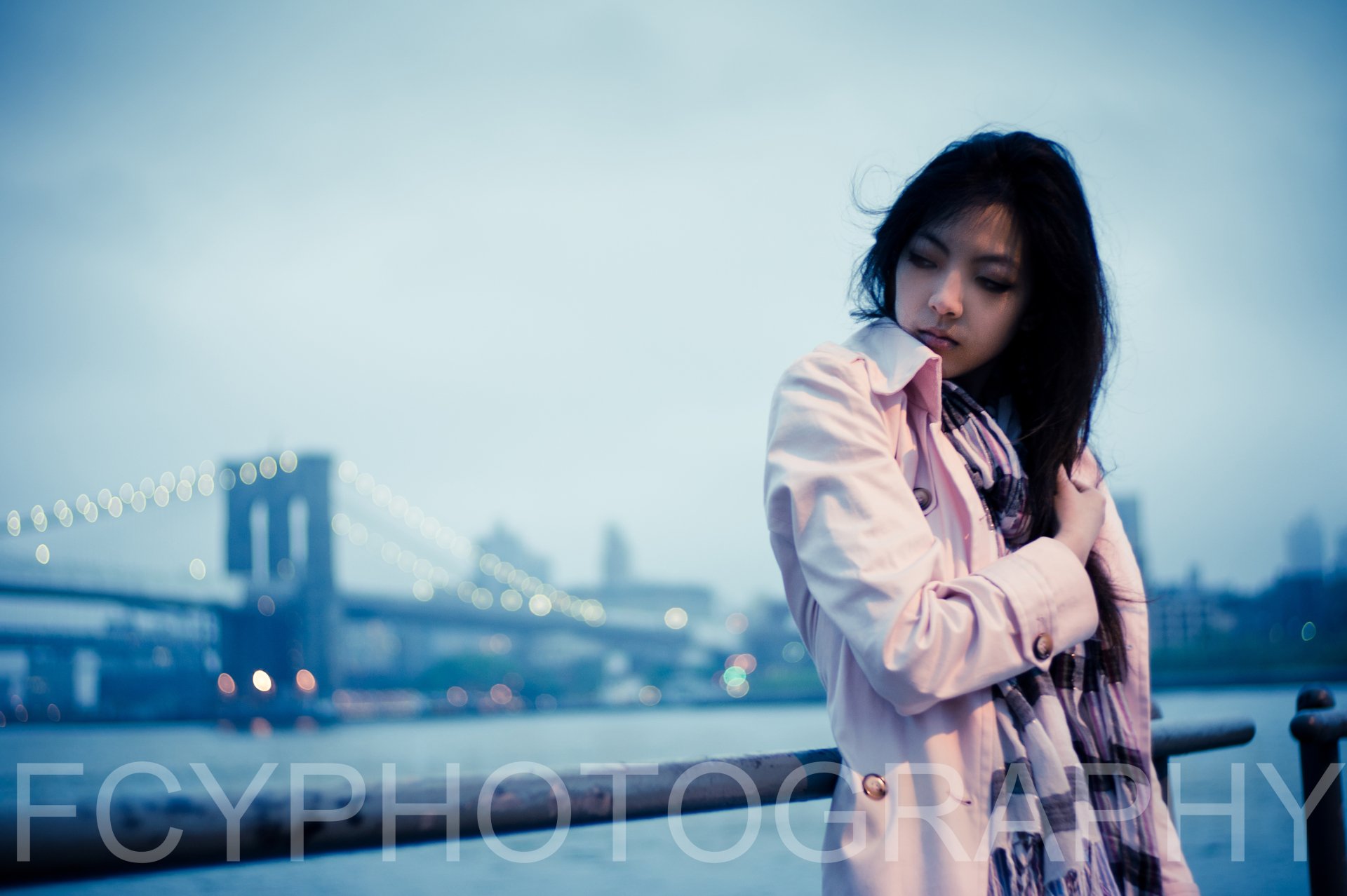A Taiwanese woman stands contemplatively near a bridge in Taipei, with soft bokeh lights creating a serene 4K Ultra HD background.