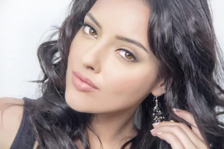 Close-up HD portrait of brunette model Kristina Akheeva with flowing hair, captivating eyes, and a subtle expression, set against a soft background.