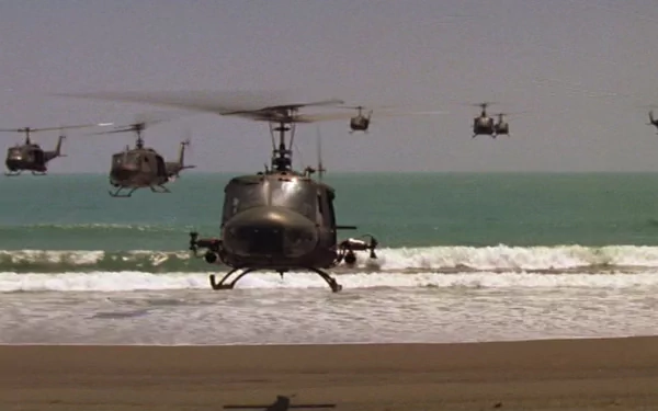A dramatic scene from *Apocalypse Now*, featuring helicopters flying over a beach with crashing waves, set against a serene sea backdrop in this HD desktop wallpaper.