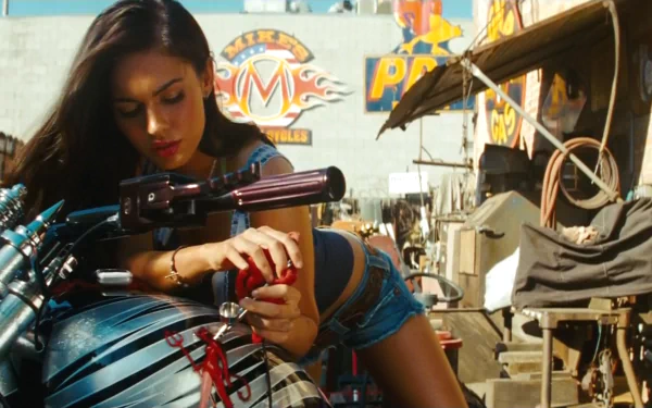 A stunning HD desktop wallpaper from Transformers: Revenge of the Fallen, featuring a character poised on a motorcycle amid a vibrant, detailed backdrop.