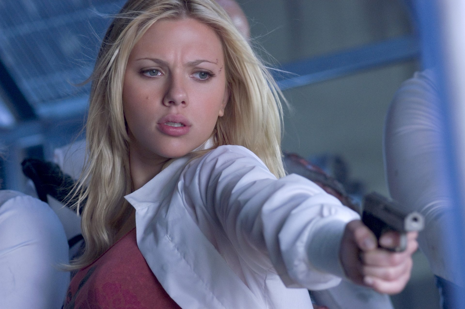 Scarlett Johansson in a gripping scene from the movie The Island, showcasing her fierce determination while aiming a firearm, captured in stunning HD quality.