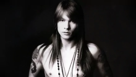 HD PC desktop wallpaper featuring a black-and-white portrait of Axl Rose with long hair, tattoos, and necklaces, capturing a classic rock music vibe.