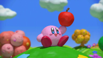 HD desktop wallpaper of Kirby from 'Kirby and the Rainbow Curse' with a red apple on a colorful backdrop.