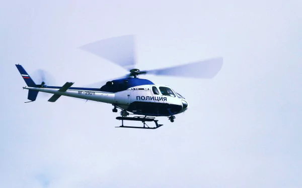 Vehicle: police Eurocopter AS355 Écureuil 2 helicopter in flight against a pale sky — 4K Ultra HD PC desktop wallpaper/background