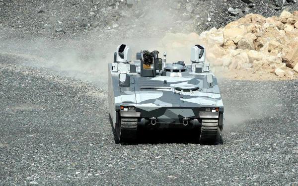 Front view of a camouflaged military Combat Vehicle 90 kicking up dust on rocky terrain, HD PC desktop wallpaper/background.