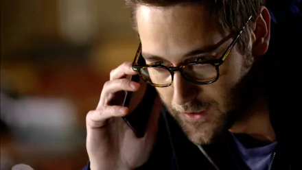 HD desktop wallpaper featuring a scene from The Blacklist with a focused character on a phone call.