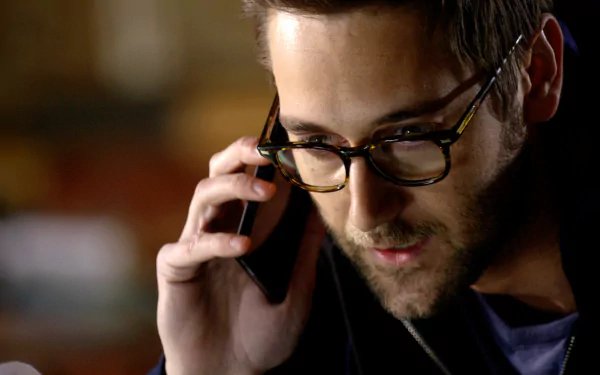 HD desktop wallpaper featuring a scene from The Blacklist with a focused character on a phone call.