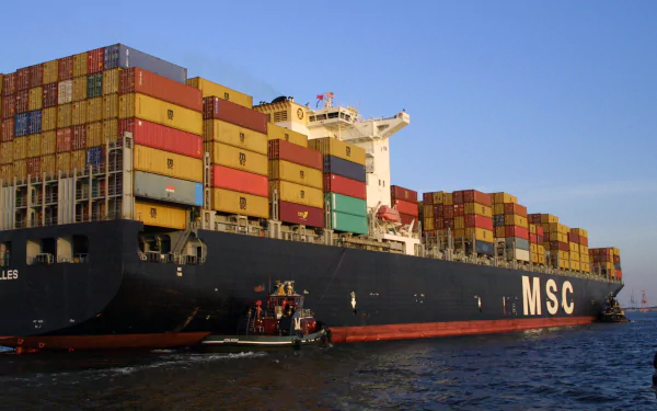 A large container ship loaded with colorful shipping containers navigates the water, showcasing maritime logistics in a striking HD desktop wallpaper.