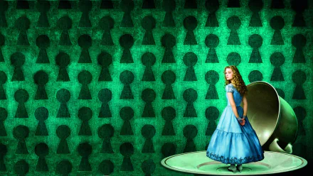 HD PC desktop wallpaper: Alice from the movie Alice in Wonderland (2010) in a blue dress standing on a giant teacup saucer against a green, keyhole-patterned background.