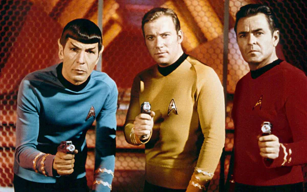 HD PC desktop wallpaper of three Starfleet officers from the TV show Star Trek: The Original Series aiming phasers on the ship's bridge.