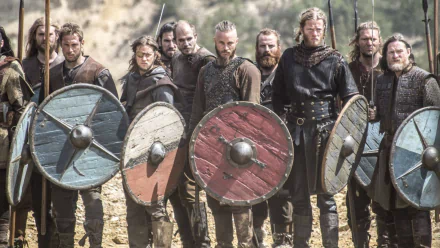 HD desktop wallpaper featuring Ragnar Lothbrok and his warriors from Vikings (2013) TV show, each holding traditional round shields in a battle-ready stance.