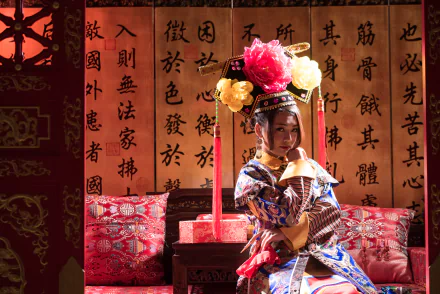 A woman dressed in traditional Taiwanese Chinese costume, Qián Fūrén style, poses gracefully on a sofa against a backdrop of calligraphy, captured in 4K Ultra HD.