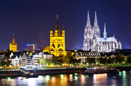Night view of Cologne's illuminated man-made skyline, featuring the iconic cathedral, captured in 4K Ultra HD as a PC desktop wallpaper and background.