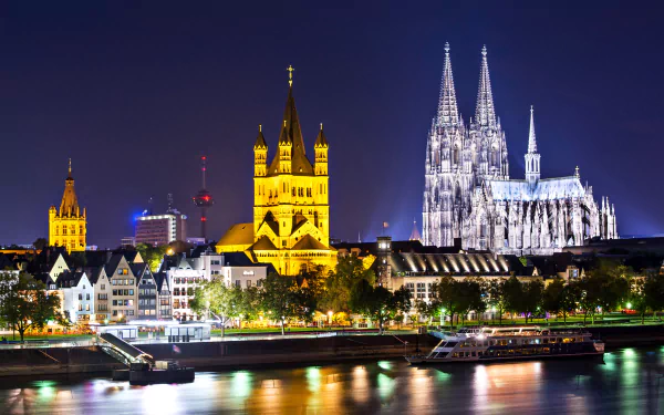 Night view of Cologne's illuminated man-made skyline, featuring the iconic cathedral, captured in 4K Ultra HD as a PC desktop wallpaper and background.