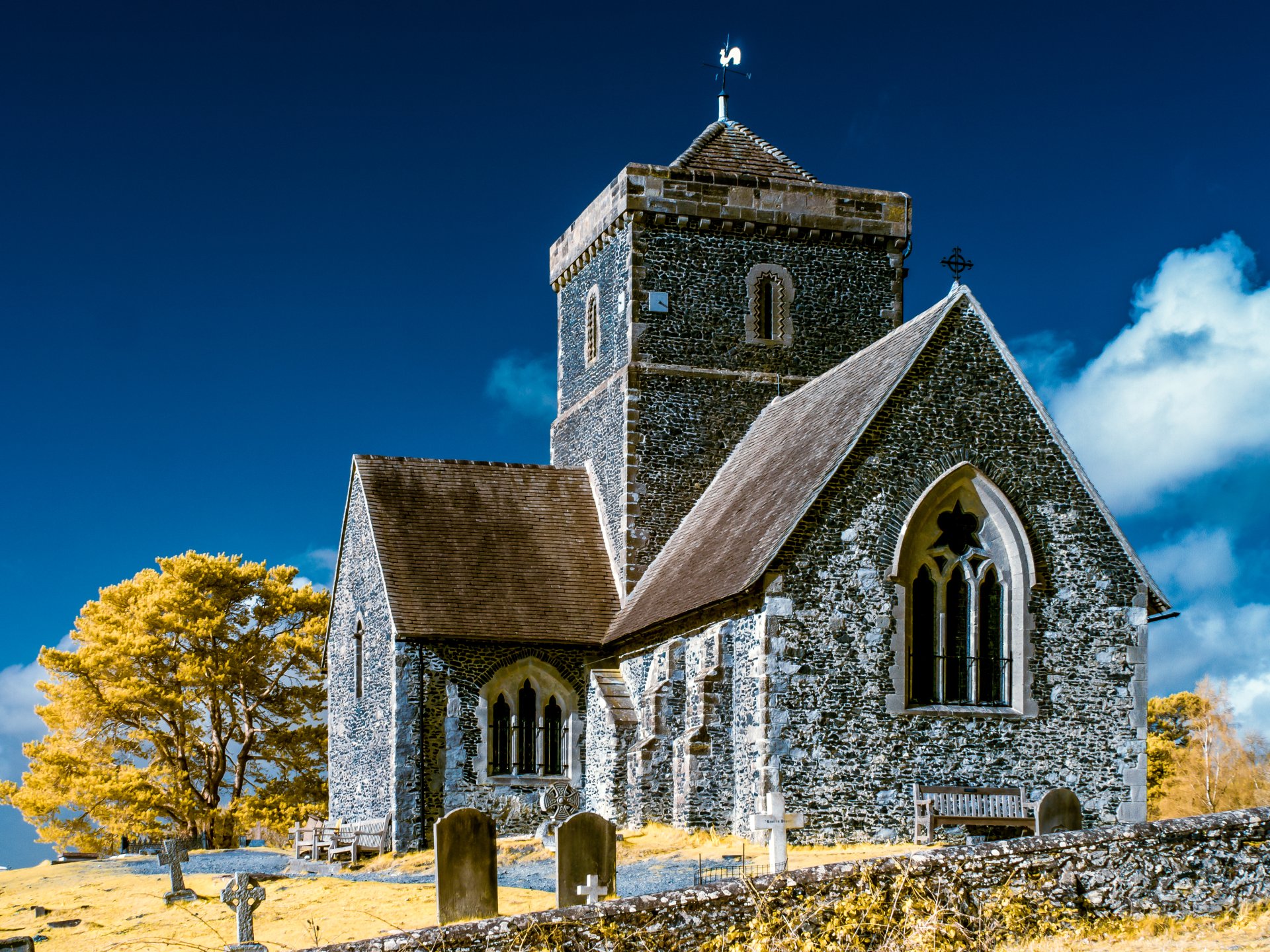Church of St Martha-on-the-Hill in Surrey, England, showcased in vibrant 4K Ultra HD with bright blue skies and autumnal yellow foliage.