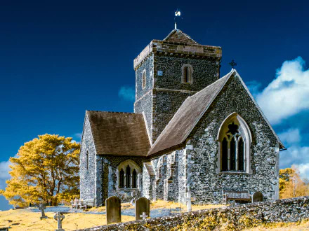 Church of St Martha-on-the-Hill in Surrey, England, showcased in vibrant 4K Ultra HD with bright blue skies and autumnal yellow foliage.