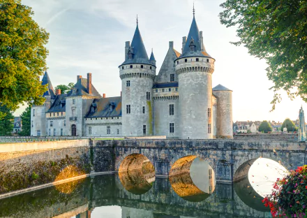 Château de Sully-sur-Loire, a historic French castle with stone towers and a bridge over a reflective moat, captured in vibrant 4K Ultra HD detail.