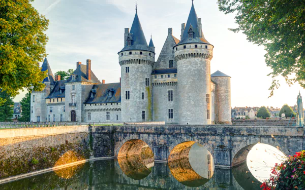 Château de Sully-sur-Loire, a historic French castle with stone towers and a bridge over a reflective moat, captured in vibrant 4K Ultra HD detail.