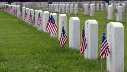 Rows of white gravestones with American flags in a cemetery, commemorating Memorial Day, presented as an HD PC desktop wallpaper and background.