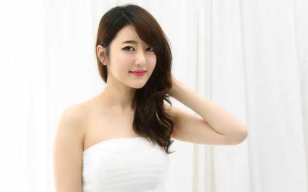 A smiling Asian woman model poses against a white background, creating a serene HD desktop wallpaper.