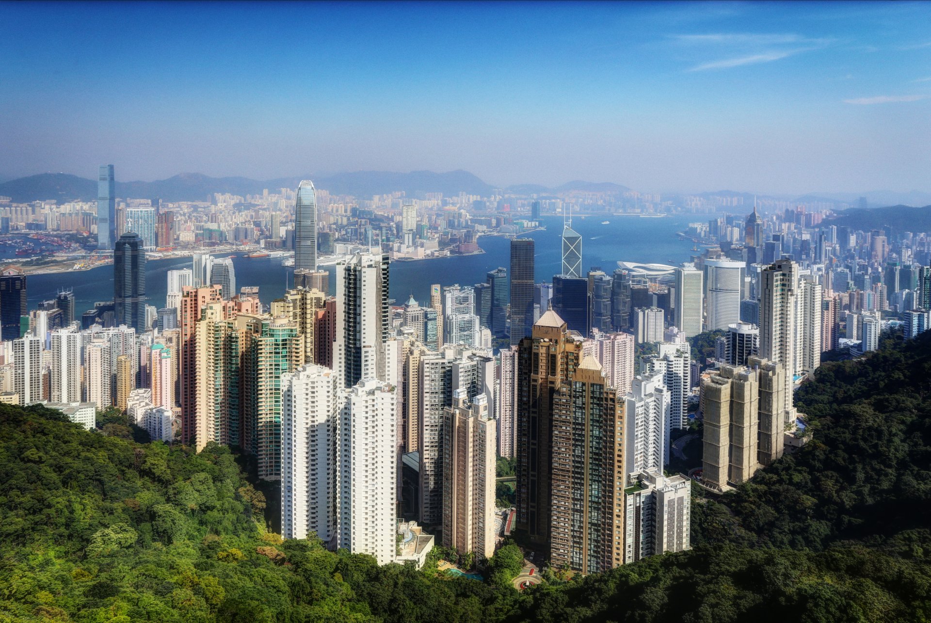 A stunning 4K Ultra HD view of Hong Kong's megapolis, showcasing the dense, man-made skyline against a backdrop of mountains and harbor in China.