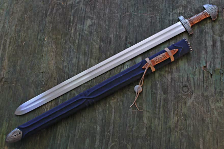 4K Ultra HD PC desktop wallpaper of a man-made double-edged sword with leather-wrapped hilt and decorated scabbard laid on weathered wooden planks.