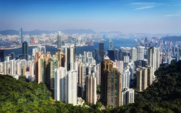 A stunning 4K Ultra HD view of Hong Kong's megapolis, showcasing the dense, man-made skyline against a backdrop of mountains and harbor in China.