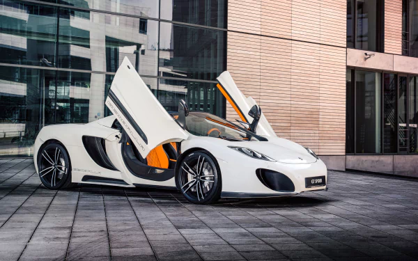 White McLaren MP4-12C supercar with butterfly doors open, parked on an urban paved area in front of modern buildings, showcased as an HD PC desktop wallpaper.