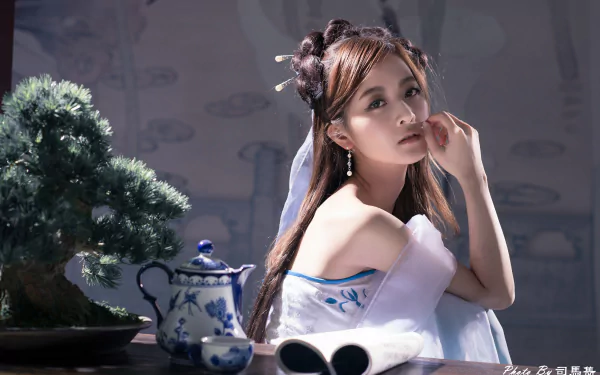 A Taiwanese woman with a hairpin poses gracefully beside a tea set and a bonsai, embodying elegance and culture in this serene 4K Ultra HD wallpaper.