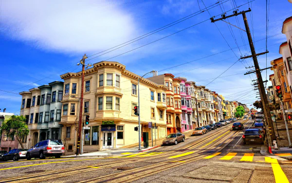 4K Ultra HD image of a colorful row of buildings along a steep San Francisco road under a bright blue sky.
