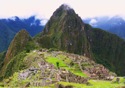 HD landscape of Machu Picchu, the iconic man-made ancient site nestled in the Andes mountains of Peru, featuring lush greenery and dramatic peaks.