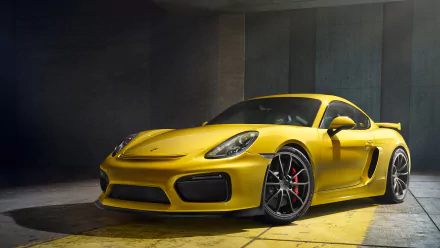 A striking yellow Porsche Cayman GT4 is showcased in this HD desktop wallpaper, highlighting its sleek design and powerful presence.