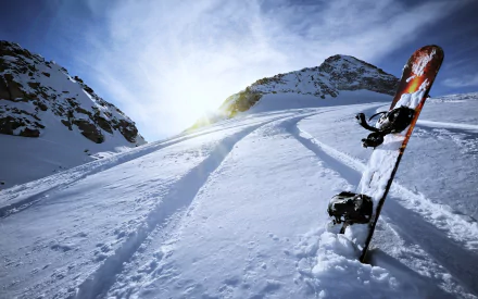 A stunning winter scene captures a snowboard resting in fresh snow, with mountain slopes in the background and the sun shining brightly, embodying the spirit of snowboarding sports.
