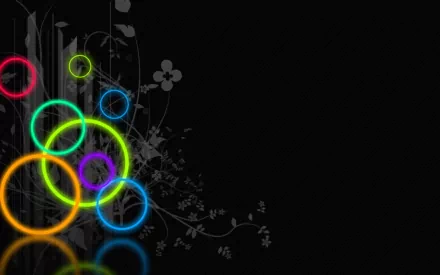 HD desktop wallpaper featuring an artistic design with vibrant, colorful neon rings on a dark background, complemented by subtle floral patterns.