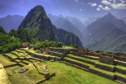 Stunning view of Machu Picchu, an iconic Inca civilization site in the Andes, Cusco, Peru, showcasing its terraced ruins against majestic mountain backdrops.