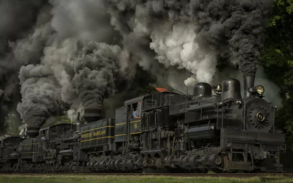 A dramatic steam train billows thick smoke as it moves, showcasing vintage power and engineering. This HD image serves as an engaging PC desktop wallpaper and background.