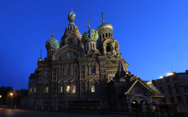 Night view of the Church of the Savior on Blood in Saint Petersburg, Russia, showcasing its intricate cathedral architecture and domes in stunning 8K Ultra HD quality.