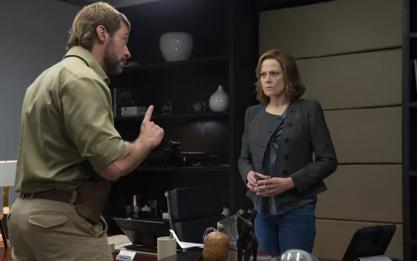 Hugh Jackman and Sigourney Weaver as Vincent Moore and Michelle Bradley in a tense scene from the movie Chappie, shown in 4K Ultra HD wallpaper quality.