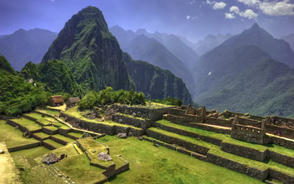 Stunning view of Machu Picchu, an iconic Inca civilization site in the Andes, Cusco, Peru, showcasing its terraced ruins against majestic mountain backdrops.