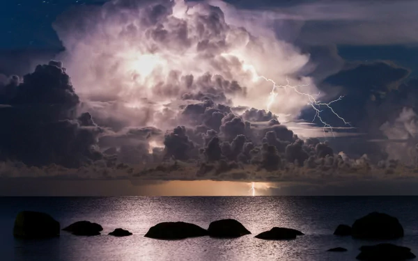 A dramatic seascape featuring a stormy ocean under a sky filled with lightning and clouds. The serene water reflects the powerful natural elements, creating a mesmerizing backdrop.