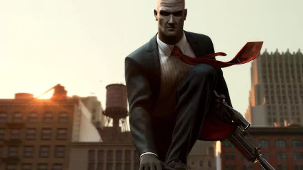 HD PC desktop wallpaper: Agent 47 from the video game Hitman: Codename 47 in a suit with a red tie, striding through a sunlit city skyline while carrying a rifle.