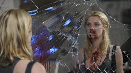 Movie-style 5K Ultra HD PC desktop wallpaper: a bloodied woman stares into a cracked mirror, reflection fractured by shattered glass, smeared blood and tense SX tape imagery.