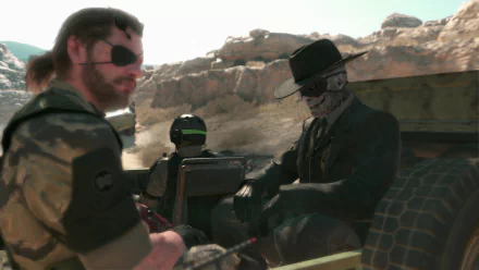 A high-definition wallpaper featuring Big Boss from Metal Gear Solid V: The Phantom Pain, alongside a mysterious character in a hat, set against a rugged desert backdrop.