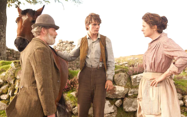 HD PC desktop wallpaper featuring a scene from the movie War Horse, showing three characters and a horse in a rustic outdoor setting.