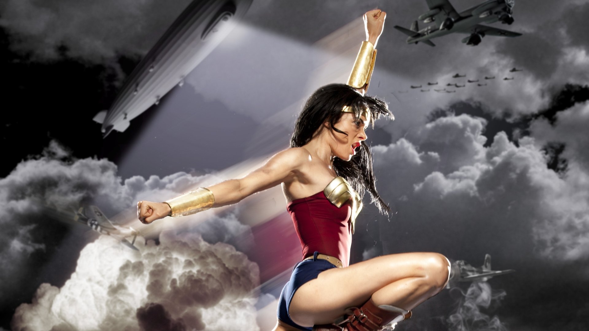 HD PC desktop wallpaper featuring Wonder Woman in a dynamic comic-style pose against a dramatic cloudy sky with vintage aircraft.