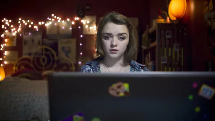 HD PC desktop wallpaper background from the movie Cyberbully: a teenage girl stares solemnly at a laptop in a dim bedroom lit by string lights.
