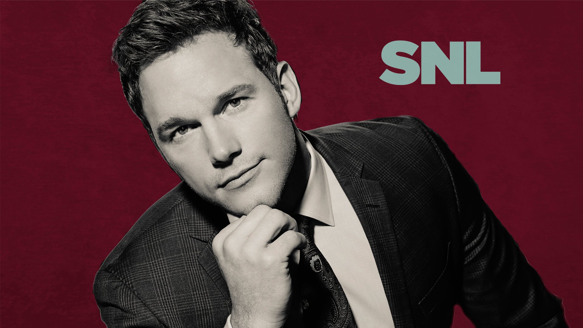 HD desktop wallpaper featuring a posed portrait of a man in a suit with the text SNL on a red background.